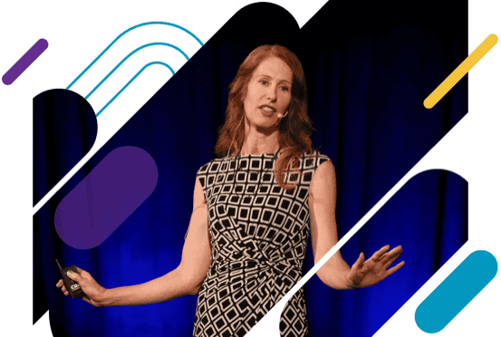 faculty member standing with papers in hand